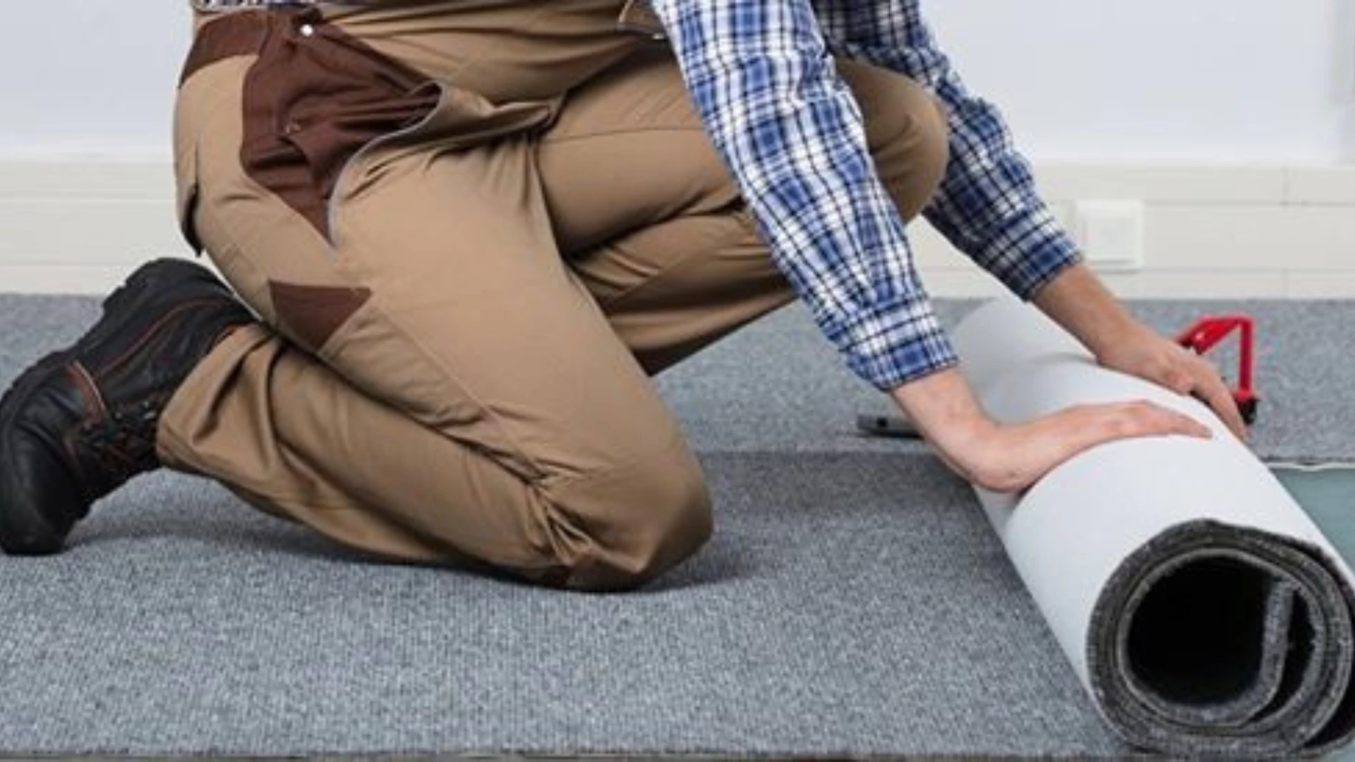 worker rolling out carpet